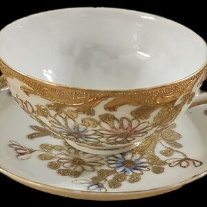 Elegant Gold and White Floral Teacup and Saucer Set
